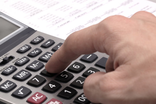 Male businessman using a calculator