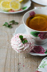 Cup of tea with marshmallow and an open book