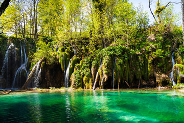 Green lake with waterfalls