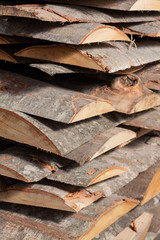 Pile of beech planks with bark