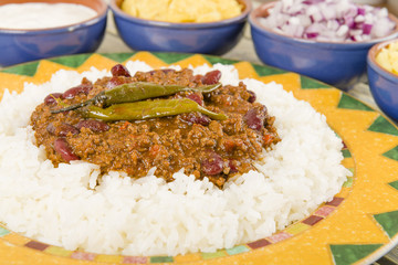Chili Con Carne with rice, onions, cheese, sour cream & chips