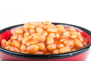 Marinated haricot beans in tomato sauce with shallots on a plate