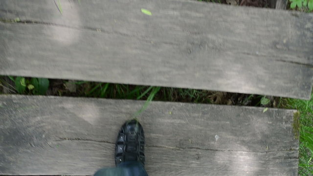 Man Legs With Shoes Climb Up On Wooden Old Stair In Park