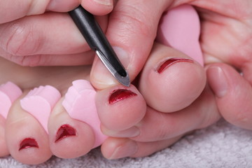 female feet red polished nails