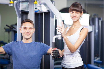 Fototapeta premium Cheerful young couple in a gym