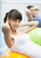 Cheerful young couple in a gym