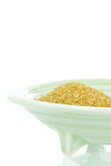 Lightly refined crystallized raw sugar in bowl