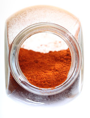 Close up jar with paprika spice isolated