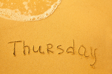 Thursday - written in sand on beach texture(days week series)
