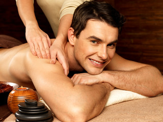 Smiling man having massage in the spa salon