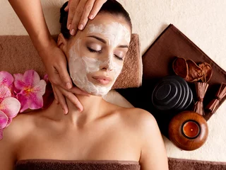 Küchenrückwand glas motiv Spa massage for woman with facial mask on face © Valua Vitaly