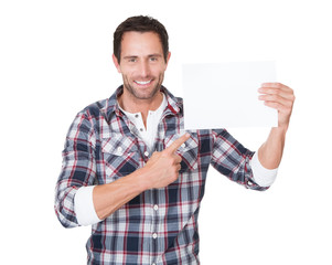 Happy middle age man presenting empty paper