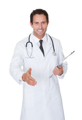 Portrait of friendly doctor offering handshake