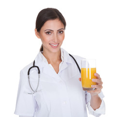 Happy Female Doctor Holding Orange Juice