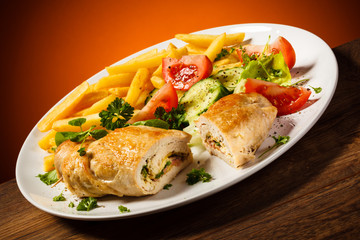Fried wrapped meat, French fries and vegetables