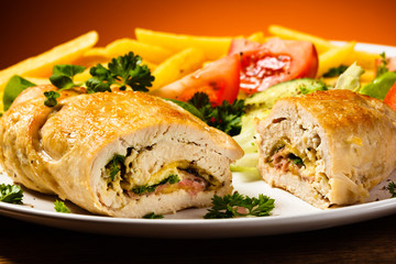 Fried wrapped meat, French fries and vegetables