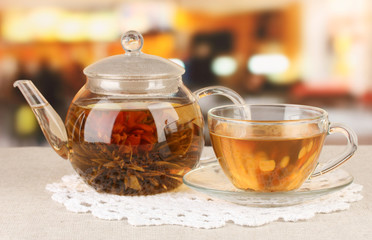 Exotic green tea with flowers in glass teapot