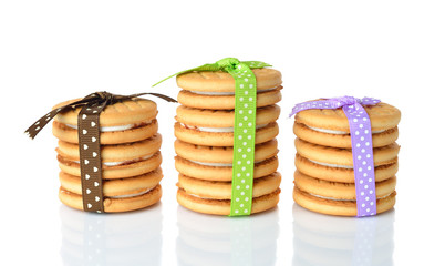 Cookies decorated with ribbons on white background