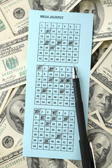 Lottery ticket, money and pen, close up