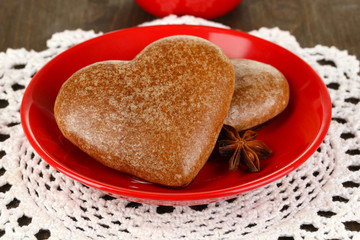 Chocolate cookies in form of heart on wooden table close-up