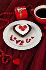 Chocolate cookie in form of heart with cup of coffee