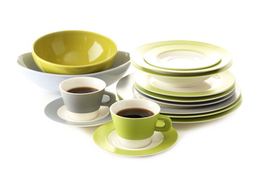 Empty bowls, plates and cups of tea isolated on white