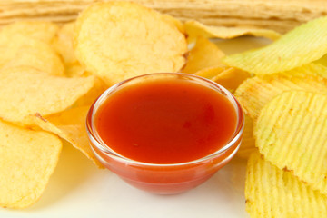 Potato chips and sauce, isolated on white