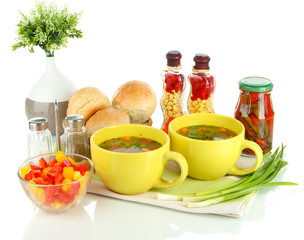 Fragrant soup in cups isolated on white