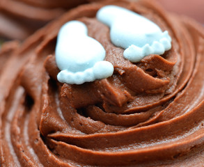 Two feet on top of Cup Cake Closeup