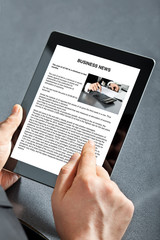 man holding tablet with business text on the screen