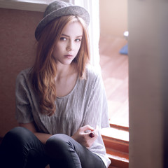 portrait of a beautiful girl in a hat.style of hipster