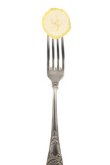 Banana slice on silver fork isolated