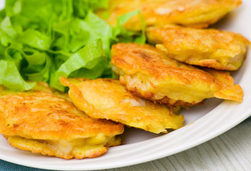 pieces of fish fillets in batter with salad