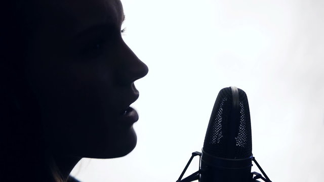 silhouette of woman singing