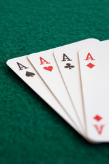 Close-up of four playing cards showing aces.
