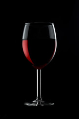 One glassed of red wine isolated on black background