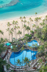 Ocean beach with pool and palm trees