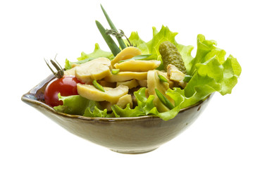 Marinated mushrooms in white saucer isolated on white