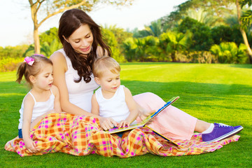 Mother with children read book