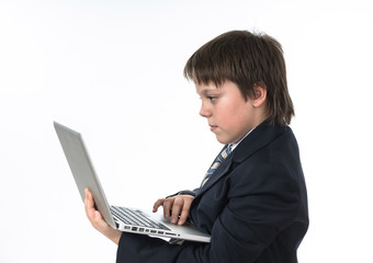 Teenage boy working in white laptop