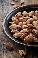 Almonds with shell on a ceramic plate