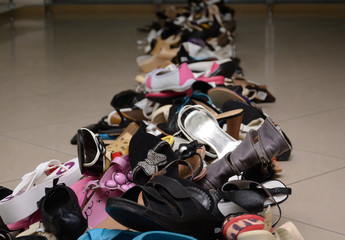 Pile of various female and male shoes in a store