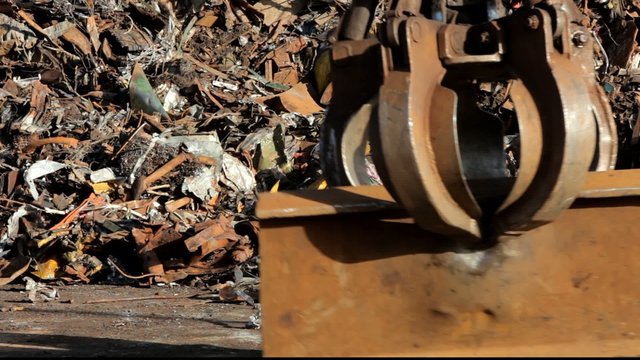 crane grabber working with recycling metal scrap