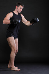 Portrait sportsman boxer in studio dark background