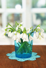 Bouquet of snowdrop flowers in glass vase,
