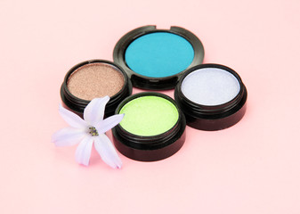 Beautiful bright eye shadows on pink background