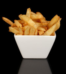 French fries in bowl isolated on black