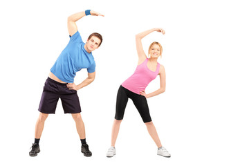 Full length portrait of a young male and female exercising