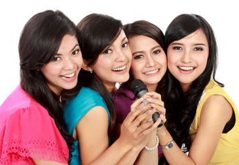 woman singing karaoke together