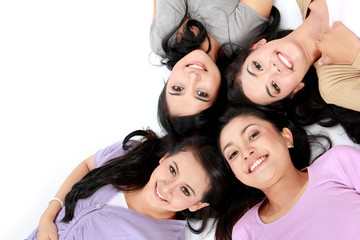teenage girls lying on white floor